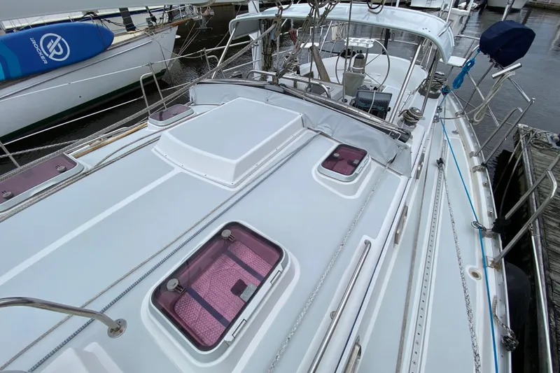 Slide: The Image of 2007 Valiant 50 sailboat deck with hatches and rigging, docked at marina. - 9
