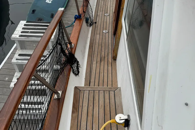 Slide: The Image of 1984 Monk 36 Trawler deck with wooden flooring and safety netting. - 10