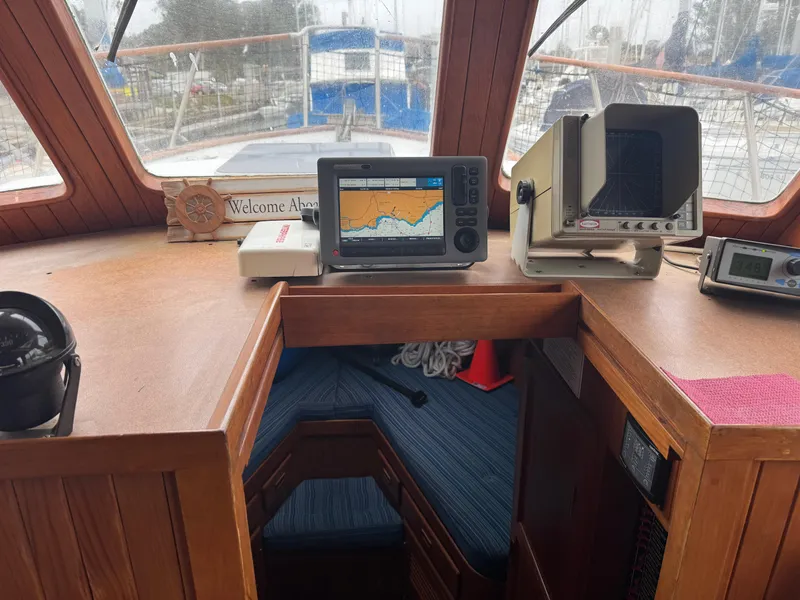 Slide: The Image of 1984 Monk 36 Trawler helm with navigation equipment and cozy cabin view. - 20