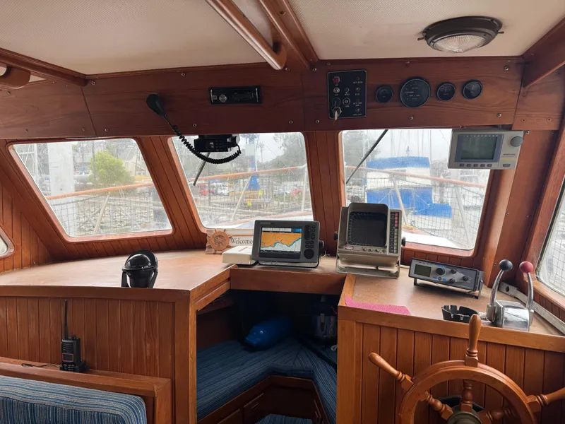Slide: The Image of 1984 Monk 36 Trawler helm with navigation equipment and wooden steering wheel. - 21
