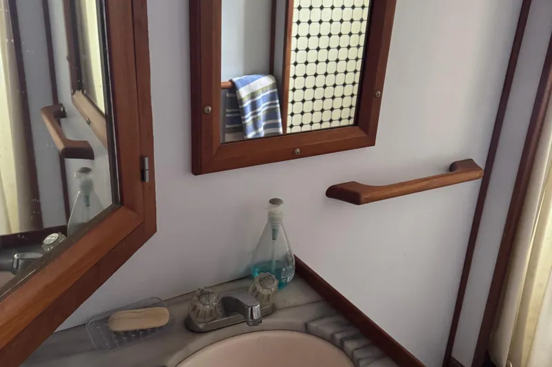 Slide: The Image of Bathroom interior of 1984 Monk 36 Trawler with wooden accents and mirror. - 24