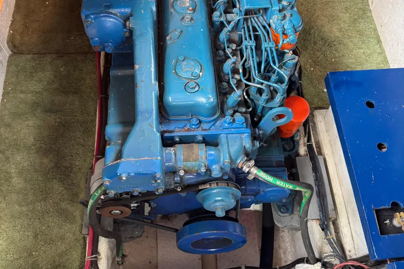 Slide: The Image of Engine of a 1984 Monk 36 Trawler, featuring blue components and visible wiring. - 27