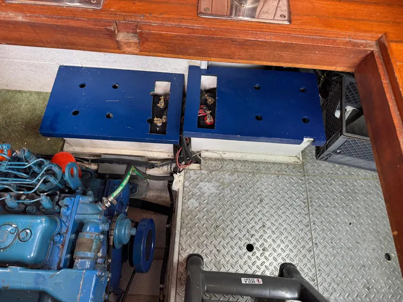 Slide: The Image of Engine compartment of a 1984 Monk 36 Trawler with blue machinery and metal flooring. - 28