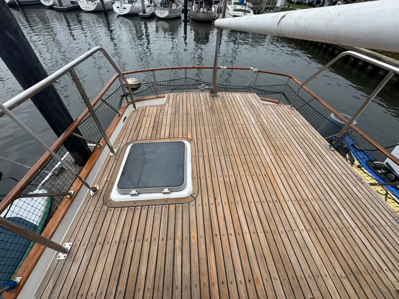 Slide: The Image of Wooden deck of a 1984 Monk 36 Trawler, docked at a marina. - 5