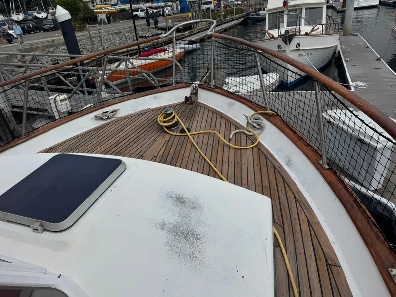 Slide: The Image of 1984 Monk 36 Trawler deck with wooden finish, docked at marina. - 7