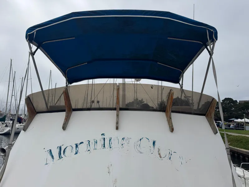 Slide: The Image of 1984 Monk 36 Trawler with blue canopy, docked at marina. - 8