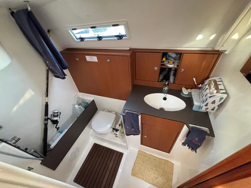 Slide: The Image of Bathroom interior of 2014 Bavaria 36 Cruiser yacht, featuring sink, toilet, and storage cabinets. - 13