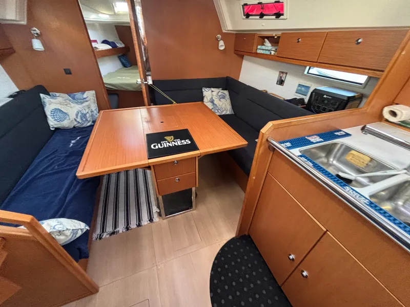 Slide: The Image of Interior of 2014 Bavaria 36 Cruiser yacht with cozy dining area and kitchenette. - 14