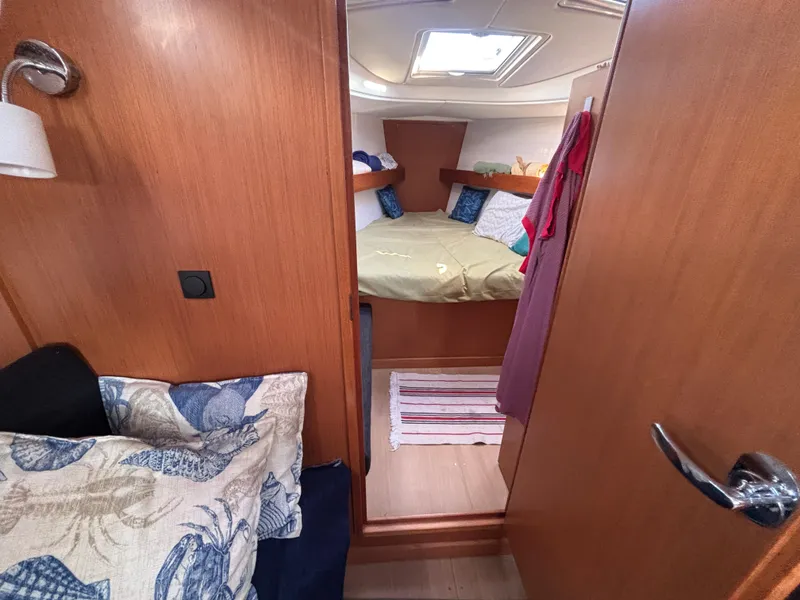 Slide: The Image of Cozy cabin interior of 2014 Bavaria 36 Cruiser yacht with wooden finish and bedding. - 15
