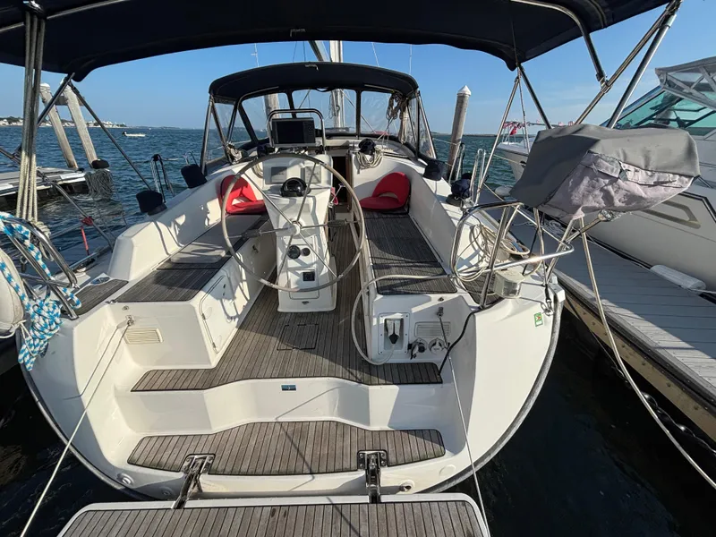 Slide: The Image of Bavaria 36 Cruiser 2014 sailboat docked, featuring spacious cockpit and dual steering wheels. - 22
