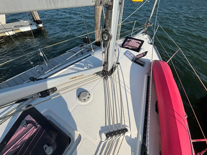 Slide: The Image of Deck view of a 2014 Bavaria 36 Cruiser sailboat, docked by the water. - 26