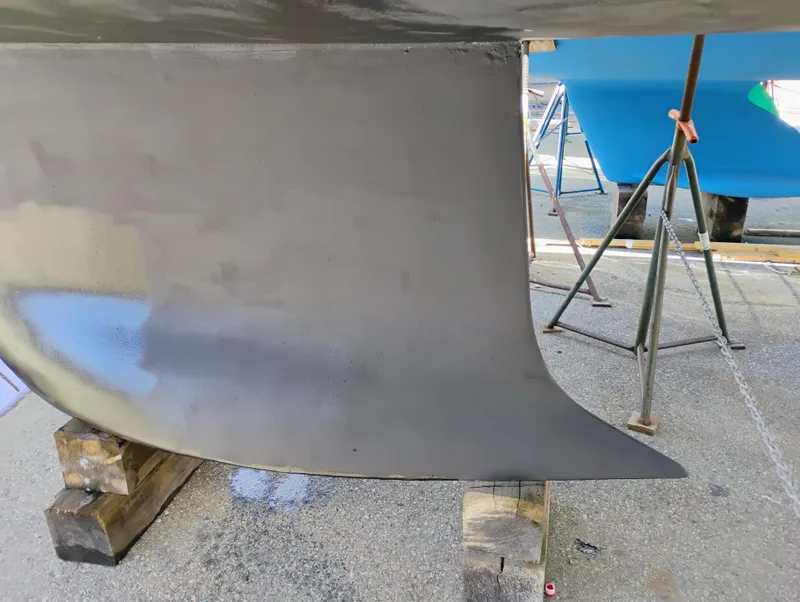 Slide: The Image of Keel of a 2014 Bavaria 36 Cruiser sailboat on a stand in a boatyard. - 34
