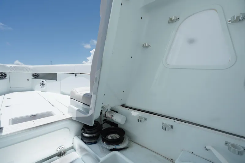 Slide: The Image of 2017 SeaVee Z39 boat interior with seating and storage compartments under a clear blue sky. - 18