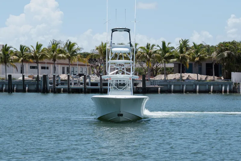 Slide: The Image of 2017 SeaVee Z39 boat cruising near a tropical dock with palm trees. - 6