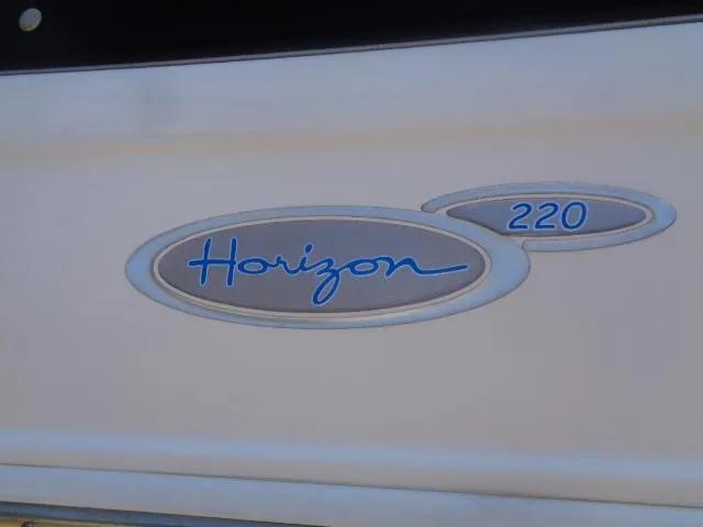 Slide: The Image of 2003 Four Winns 220 Horizon logo on boat exterior. - 10