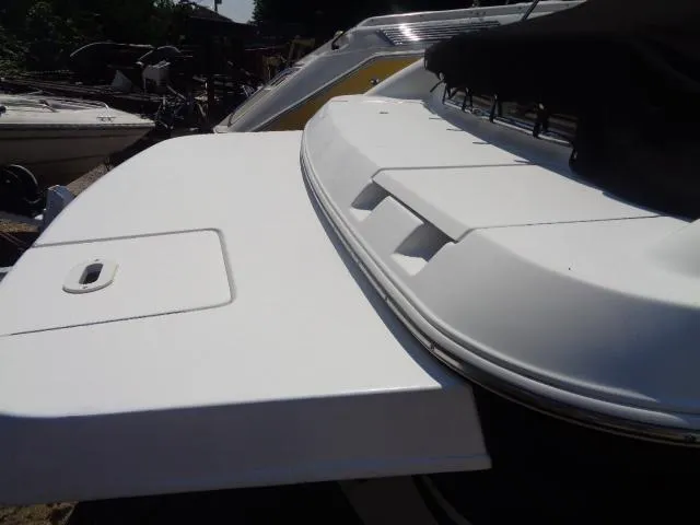 Slide: The Image of 2003 Four Winns 220 Horizon boat with white deck and covered seating area. - 11