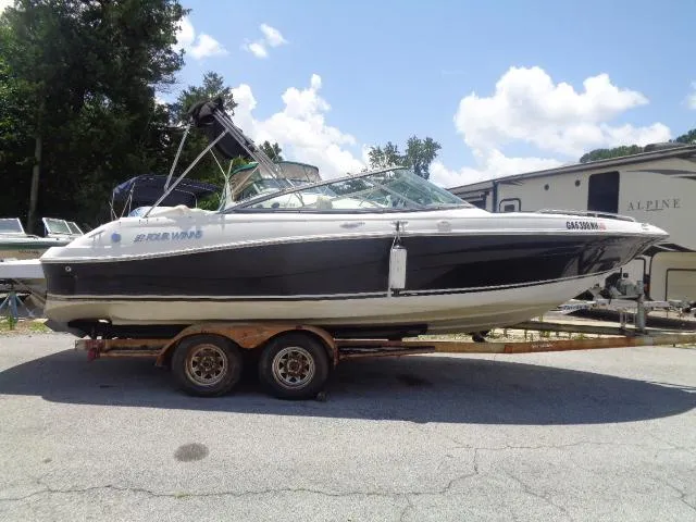 The Image of 2003 Four Winns 220 Horizon boat on trailer, parked outdoors under a sunny sky. - 3
