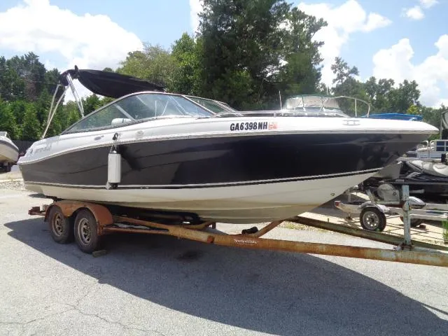 Slide: The Image of 2003 Four Winns 220 Horizon boat on trailer, black and white exterior, parked outdoors. - 5