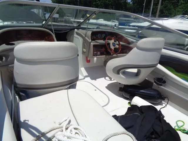Slide: The Image of 2003 Four Winns 220 Horizon boat interior with white seating and dashboard. - 8