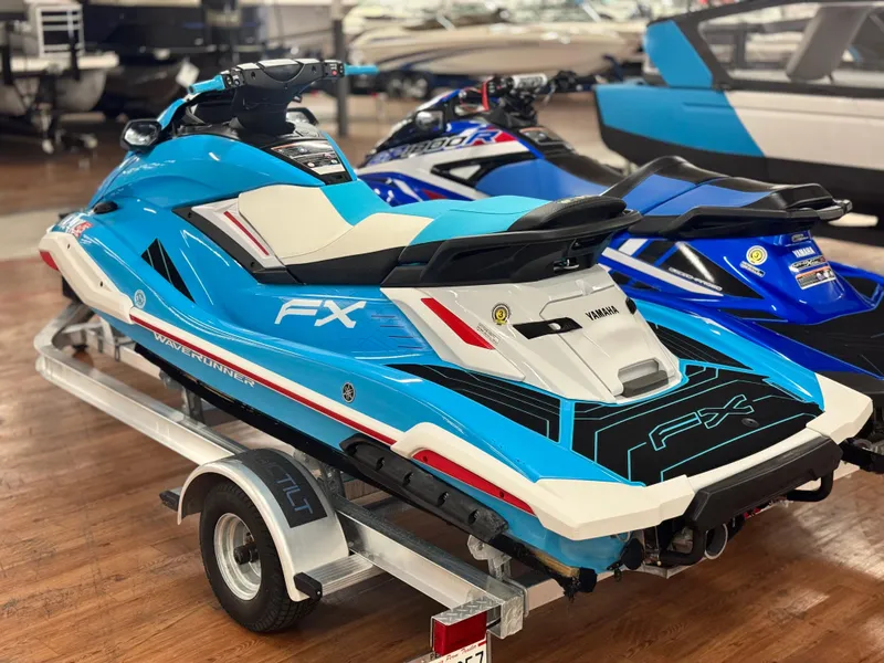 Slide: The Image of 2022 Yamaha WaveRunner FX SVHO in showroom, vibrant blue and white design. - 11
