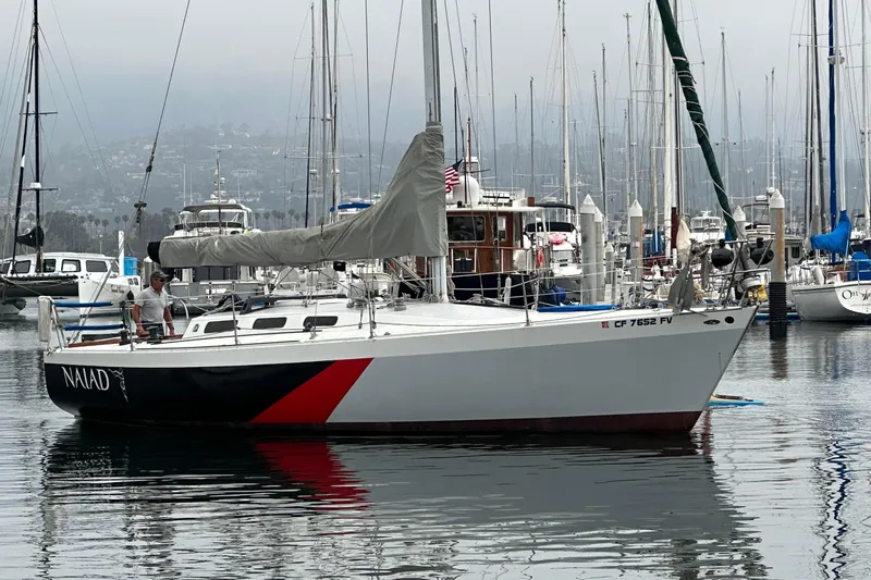 The Image of Sailboat "Naiad" by C & B Marine, Custom model, 1976, docked in a marina. - 0