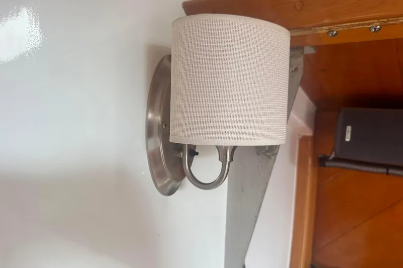 Slide: The Image of Wall-mounted light fixture with a beige fabric shade on a 1976 C&B Marine boat. - 18