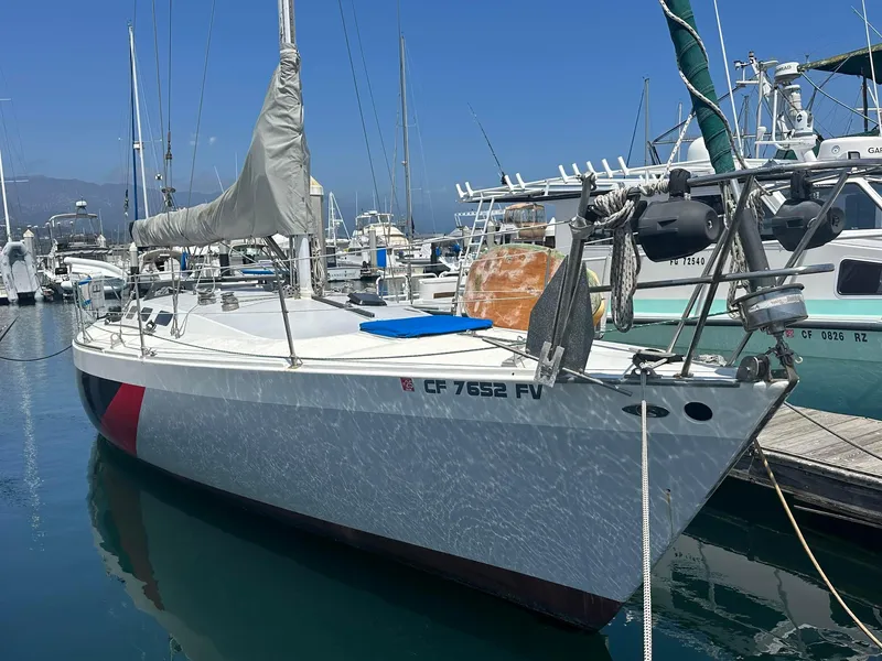 Slide: The Image of 1976 Custom C&B Marine sailboat docked in a marina under clear blue skies. - 2