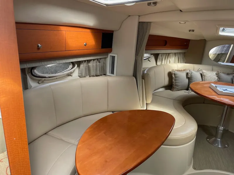 Slide: The Image of Luxurious interior of 2005 Chaparral Signature 330 yacht with elegant seating and wooden table. - 14