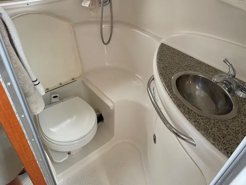Slide: The Image of 2005 Chaparral Signature 330 boat bathroom with toilet, sink, and granite countertop. - 16