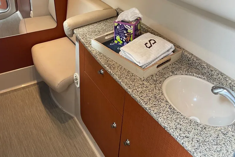 Slide: The Image of 2005 Chaparral Signature 330 bathroom with granite countertop, sink, and wooden cabinetry. - 17