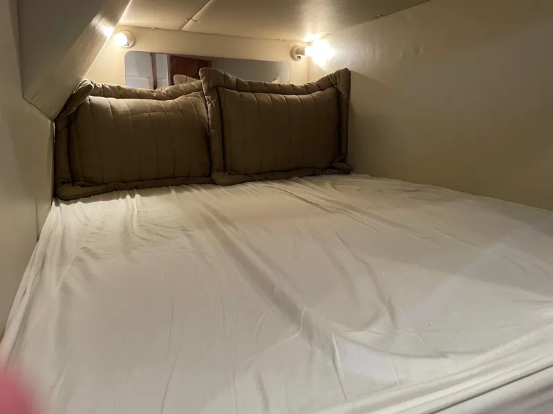 Slide: The Image of Cozy sleeping area in 2005 Chaparral Signature 330 boat cabin with soft lighting. - 18