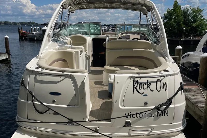 Slide: The Image of 2005 Chaparral Signature 330 boat docked, rear view, with "Rock On" text, Victoria, MN. - 2