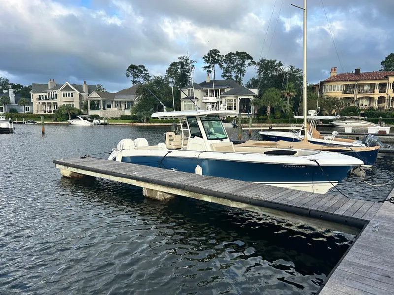 The Image of 2017 Boston Whaler 330 Outrage docked in a scenic marina setting. - 0