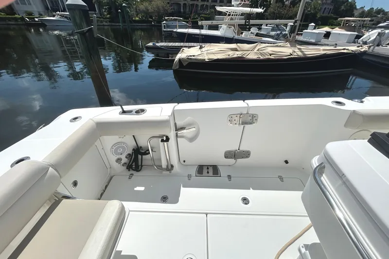 Slide: The Image of 2017 Boston Whaler 330 Outrage boat interior, docked in a marina. - 10