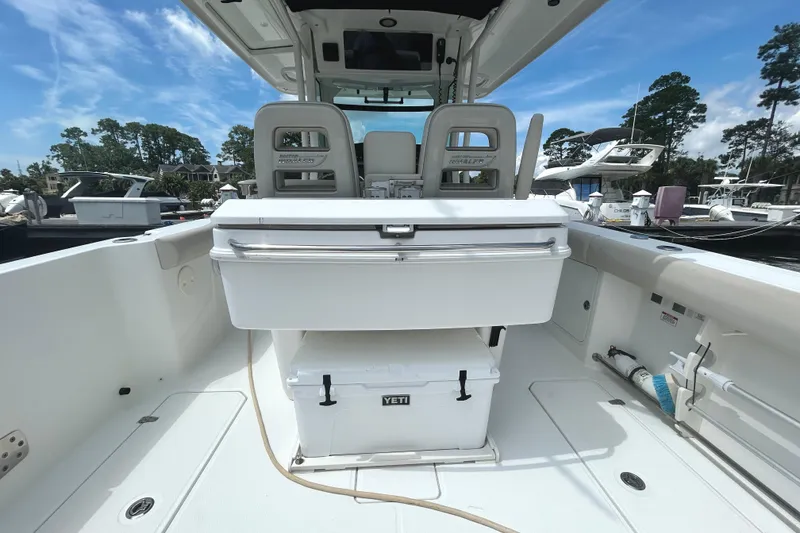 Slide: The Image of 2017 Boston Whaler 330 Outrage boat interior with seating and Yeti cooler. - 13