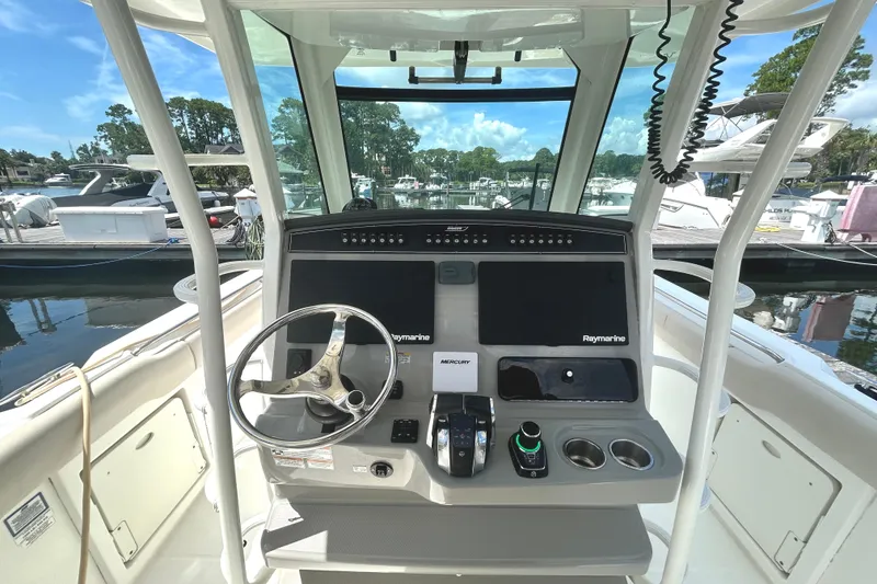 Slide: The Image of 2017 Boston Whaler 330 Outrage helm with Raymarine electronics at marina. - 15