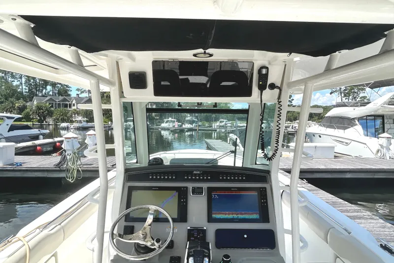 Slide: The Image of 2017 Boston Whaler 330 Outrage helm with advanced navigation system at marina. - 16