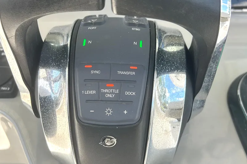 Slide: The Image of Throttle controls of a 2017 Boston Whaler 330 Outrage boat, featuring various operational buttons. - 18
