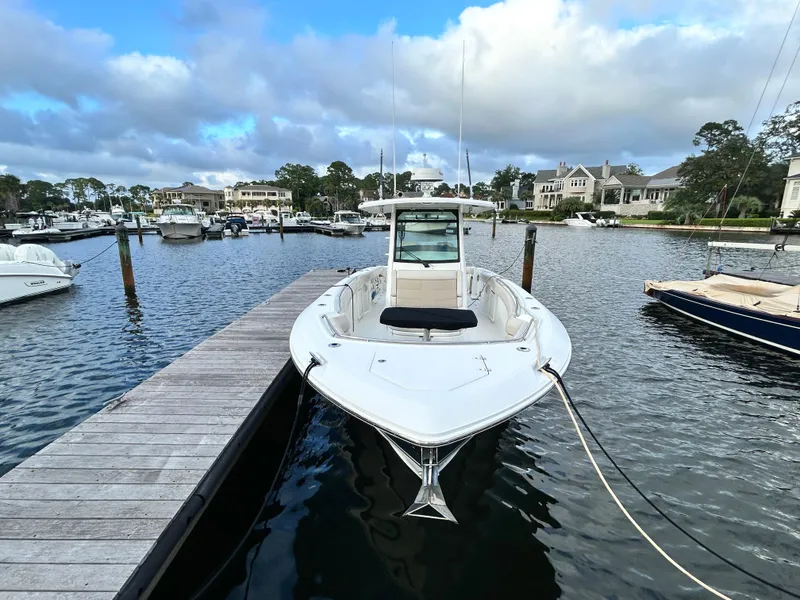 Slide: The Image of 2017 Boston Whaler 330 Outrage docked in a scenic marina. - 2