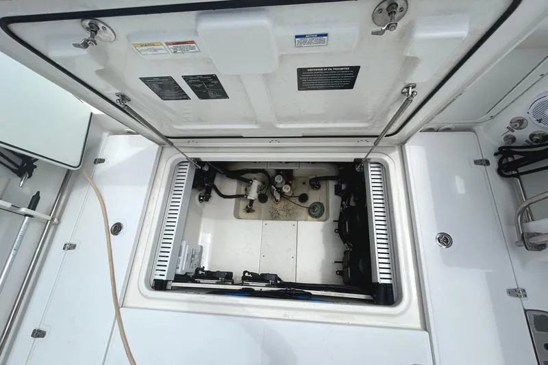 Slide: The Image of 2017 Boston Whaler 330 Outrage engine compartment, open hatch view. - 25