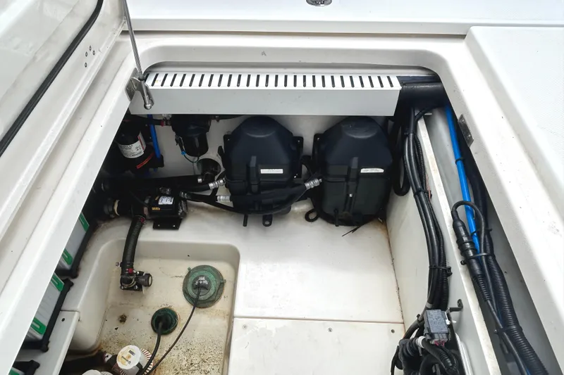 Slide: The Image of 2017 Boston Whaler 330 Outrage engine compartment with visible wiring and components. - 26