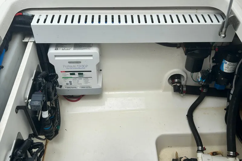 Slide: The Image of 2017 Boston Whaler 330 Outrage engine compartment with ProNautic 12-30P charger and wiring. - 27