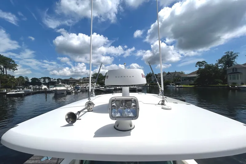 Slide: The Image of Boston Whaler 330 Outrage 2017 on calm water under a partly cloudy sky. - 3