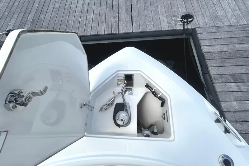 Slide: The Image of 2017 Boston Whaler 330 Outrage boat anchor compartment at dock. - 32