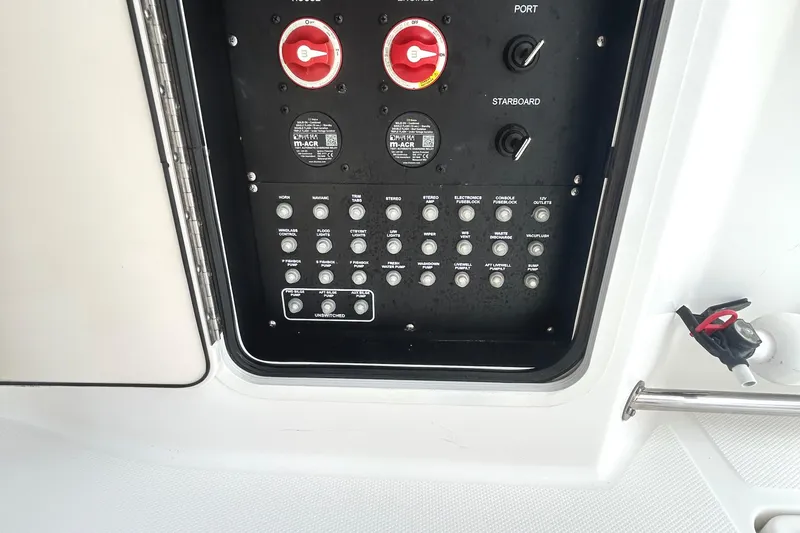 Slide: The Image of Control panel of a 2017 Boston Whaler 330 Outrage boat, featuring switches and dials. - 33