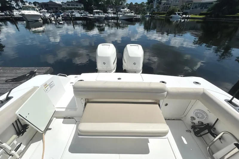Slide: The Image of 2017 Boston Whaler 330 Outrage boat with dual engines docked at marina. - 9