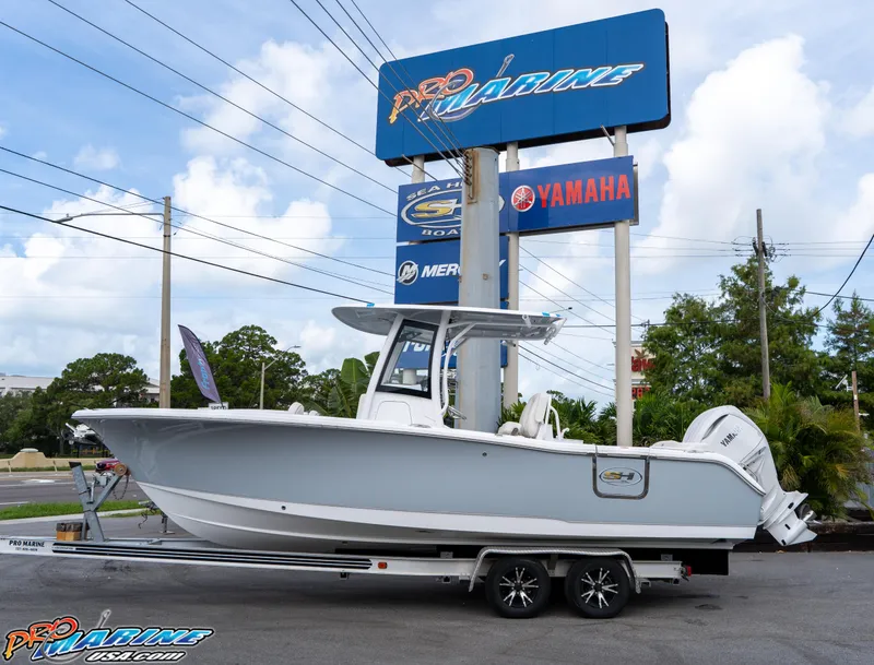 The Image of 2026 Sea Hunt Ultra 255 SE boat on trailer at Pro Marine dealership. - 1