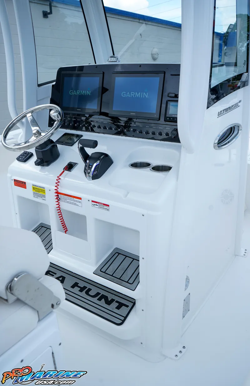 Slide: The Image of Control panel of 2026 Sea Hunt Ultra 255 SE boat with steering wheel and digital displays. - 15