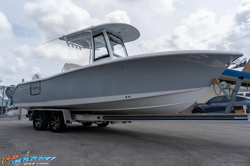 Slide: The Image of 2026 Sea Hunt Ultra 255 SE boat on trailer with Yamaha engine, parked outdoors. - 5