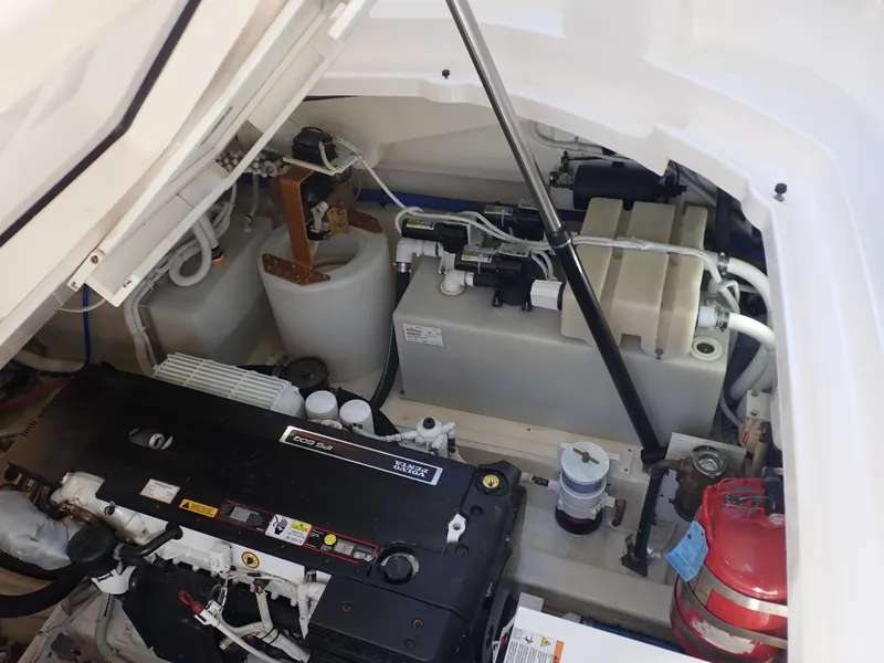Slide: The Image of Engine compartment of 2009 Tiara Yachts 4300 Sovran, showcasing mechanical components and fire extinguisher. - 15